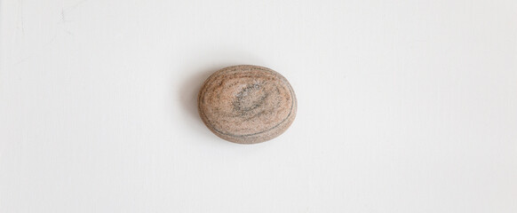 Pebble stone on white paper