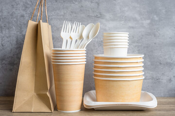 Eco friendly food packaging on table background. natural container: cup, plate, spoon and fork. zero waste, pollution, earth day, free plastic, world Environment day concept