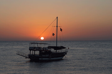 Cruise boat at sea at sunrise.