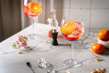 Italian Aperol Spritz cocktail with orange slices on gray stone table. Summer drink, homemade sangria. Copy space