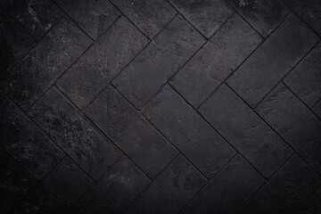 Black Stone wall texture. Floor pattern or abstract tile background. Herringbone pattern.