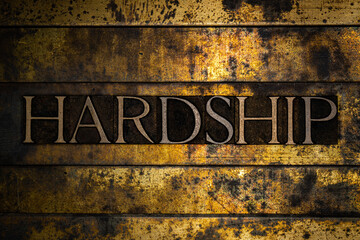 Hardship text on textured grunge copper and vintage gold background