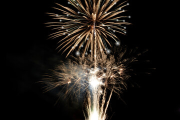 Fototapeta premium Fireworks display isolated on black with copy space. Pyrotechnic background for greeting card or festival celebration poster. Vertical format