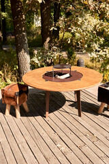 Kettle Grill Pit with Cast Iron Grid with flames . Round table-cooking surface. Hot BBQ on Backyard