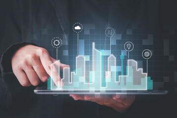 Smart city technology concept. Business hand holding  digital tablet low poly smart city on screen.