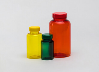 Multi colored transparent plastic pill jars on a white background. Isolated