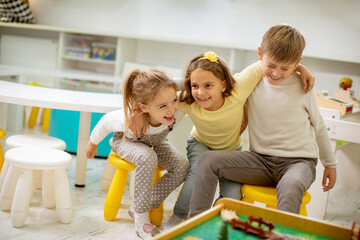 Group of kindergarten kid friends sitting and having fun