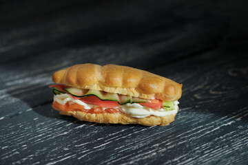 Snack eclairs profiteroles with creamcheese, cucumber and smoked salmon red fish. tasty appetizer on black rustic table., holiday lunch, weekend menu