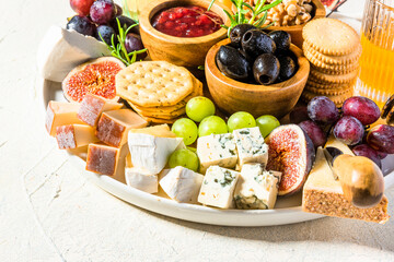 Tasty Appetizer Cheese Board with Various Food on Platter