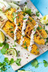 Grilled Corn Cob in Husk with Coriander, LIme, Salt and Garlic Sauce. Mexican Street Food