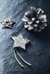 Fototapeta na wymiar Christmas star on dark stone background. Close up. copy space. 