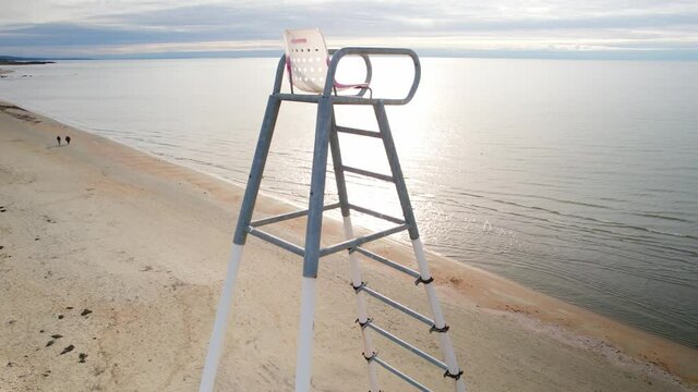 Aerial view of a tall lifeguard chair on a beach in Falkenberg, Sweden. 4K drone footage.
