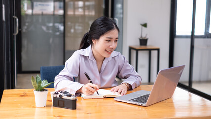 Young Woman using Laptop in the office.