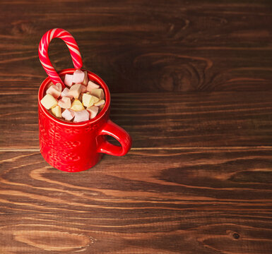 Red Hot Chocolate Cup With Lollipop Candy, Marshmallows On A Rustic Background.