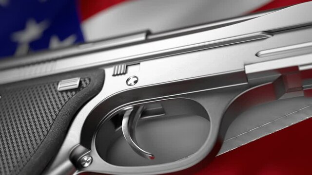 Silver semi-automatic pistol close-up against American flag