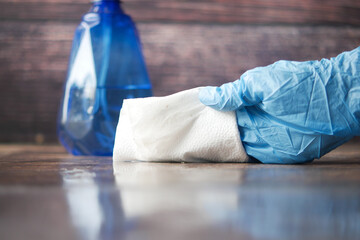 close up of person hand cleaning table with cloth 