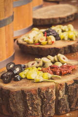 Fresh peppers and olives for sale at street market. Healthy food containing vitamins. Mediterranean snack