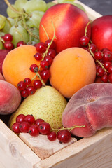 Heap of fruits in wooden box as healthy snack or dessert containing natural vitamins