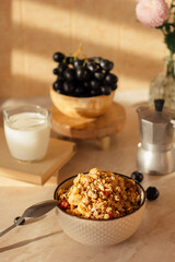 Breakfast. Porridge in a plate on the table. Milk in a cup. Healthy food