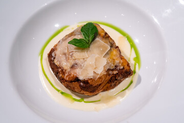 Closeup tasty traditional beef lasagne with cheese and basil leaves.