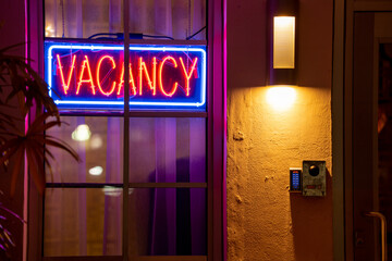 Fototapeta na wymiar Hotel with neon vacancy sign lit