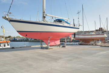 45 ft cruising sailboat standing on land in a yacht marina. Transportation, nautical vessel, repair...