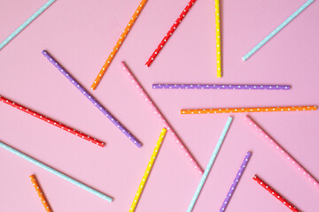 Colorful paper straws for drinking cocktails on a pink background. Flat lay. Ecology biodegradable product. Plastic free, ecology concept.