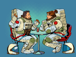 Astronauts man and woman couple date in a cafe. Meeting two friends