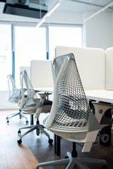 Fototapeta na wymiar Modern office interior. White chair and table in a modern corporation.Office desk for businessmen
