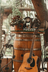 Fototapeta na wymiar Birthday decoration - Guitar leaning on a wooden barrel in a restaurant at a celebration