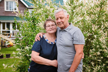 Senior couple, mature man and woman at their house, outdoors