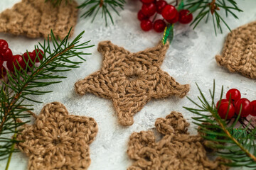 Christmas handmade star close up with spruce twigs on a light background. Christmas eco friendly toys.