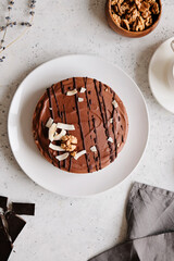 Chocolate raw vegan cake - healthy dessert made from coconut milk, butter, cashew, cacao, walnut. Top view