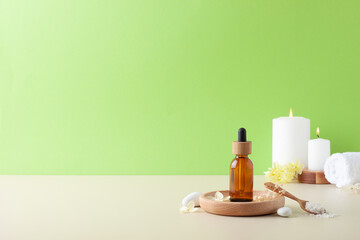 Spa treatment with natural skin care products, brush and flowers on green background. Close up, copy space