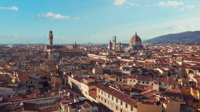 Aerial view. Historically and Culturally Rich Italian Town on the Sunny Day. Beautiful Old City With Medieval Churches and Cathedrals. Clouds in the background