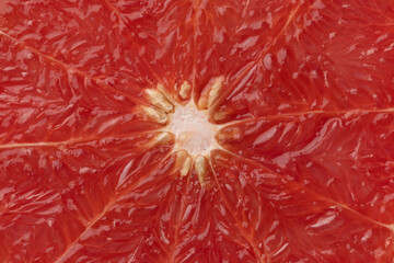 Fruit flesh of red grapefruit close up full frame as background 