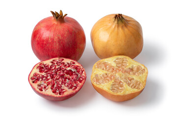 Whole and halved red and white pomegranate close up isolated on white background  