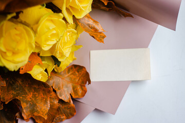 card mockup with autumn bouquet of yellow roses and oak leaves. thanksgiving letter