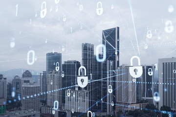 Hologram of padlock icons over panoramic city view of Kuala Lumpur to protect business, Malaysia, Asia. The concept of information security shields. Double exposure.