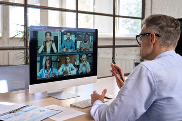 Corporate leader manager leading videoconference with diverse team business people having digital...