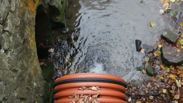 Rainwater flows from a large diameter plastic sewer pipe. City sewerage.