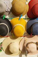 Women's hat display with wooden clamp.