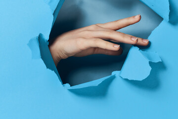 female hand blue background posing glamor model