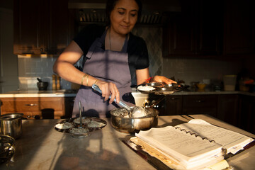 Woman cooking idlis at home 