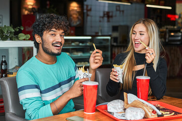couple a Hindu man and a girl eat potatoes and talk