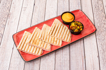 Mexican synchronized quesadillas stuffed with cheese with cooked ham and cream cheddar cheese and...