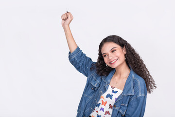 A joyous teenage asian raises her arm in glee. Possibly grooving to a beat. Isolated on a white...