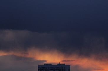 clouds over the city house during sunset