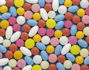 Background from medical pills of white, blue and other colors.