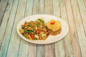 Combination plate of chicken with noodles and vegetables, chaufa rice and wantun with Peruvian recipe